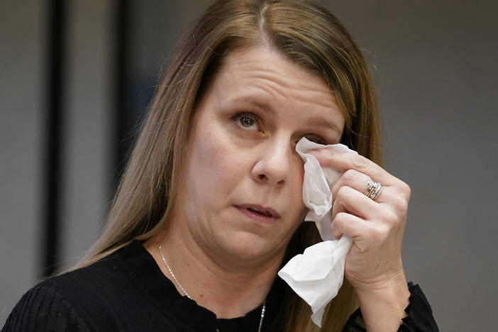 Gabby Petito's mother Nichole Schmidt, wipes a tear from her face during a news conference Thursday, Nov. 3, 2022, in Salt Lake City. Gabby Petito's family filed a wrongful death lawsuit alleging that police failed to recognize their daughter was in a life-threatening situation last year when officers investigated a fight between her and her boyfriend.