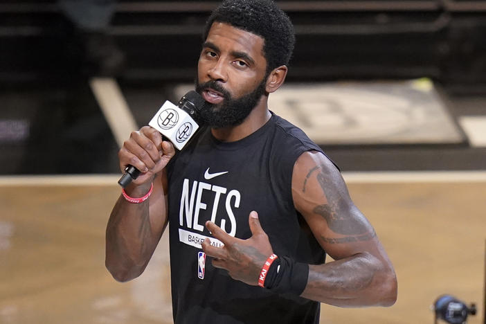 Brooklyn Nets' Kyrie Irving speaks before the team's NBA basketball game against the New Orleans Pelicans on Oct. 19, 2022, in New York. The Nets are suspending Irving for at least five games without pay, saying they were dismayed by his failure to "unequivocally say he has no antisemitic beliefs."