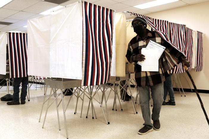 People cast early ballots in the upcoming midterm elections at a polling station on Tuesday in Anchorage, Alaska.