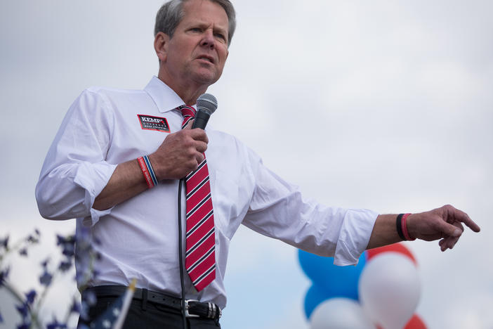 Republican Gov. Brian Kemp speaks to supporters at a campaign stop in Marietta, Ga., on Nov. 3. Kemp emphasized how he kept businesses open during the pandemic despite criticism from Democrats and health experts. "Who was fighting for you then when the political winds were blowing a different way?" he said.