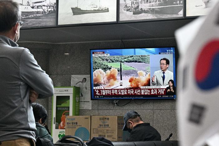 Visitors watch a news broadcast showing file footage of a North Korean missile test at the ferry terminal of South Korea's eastern island of Ulleungdo, in the East Sea, also known as the Sea of Japan, on Thursday.