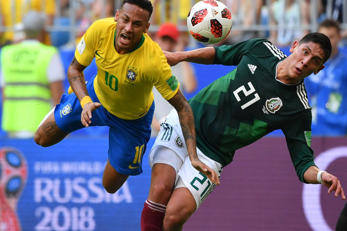 Mexico's defender Edson Alvarez (right) fouls Brazil's forward Neymar during the Russia 2018 World Cup round of 16 football match between Brazil and Mexico at the Samara Arena in Samara, Russia on July 2, 2018.