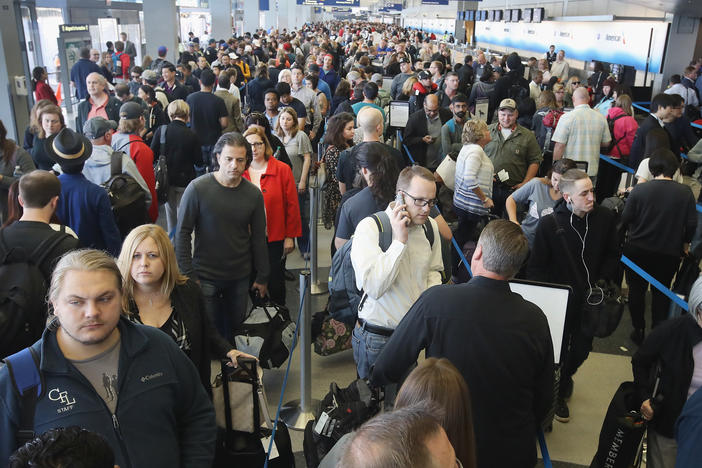 Passengers at O'Hare International Airport, in Chicago, wait in line to be screened at a Transportation Security Administration checkpoint in 2016.