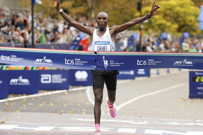 Evans Chebet, of Kenya, crosses the finish line first in the men's division of the New York City Marathon on Sunday.