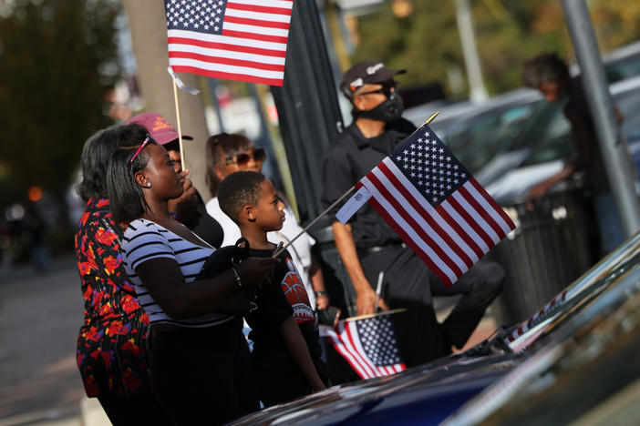 People look on during the Cherry Blossom Festival Veterans Day Parade Sunday in Macon, Ga. Georgia's Senate race, which could decide control of the Senate, might not be resolved for a month.
