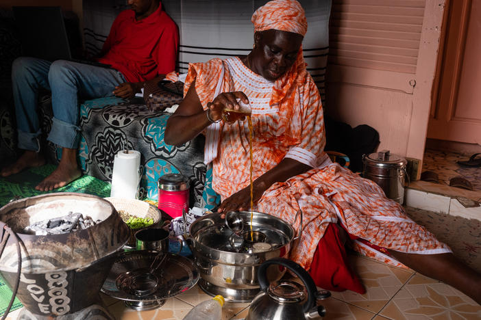 Yaram Fall makes tea in her home in Guet N'dar, Senegal on October 6. She is the head of an economic interest group for women who preserve fish. She represents hundreds of Senegalese women who do her kind of work, and she discourages youth from taking the boat to Europe clandestinely.