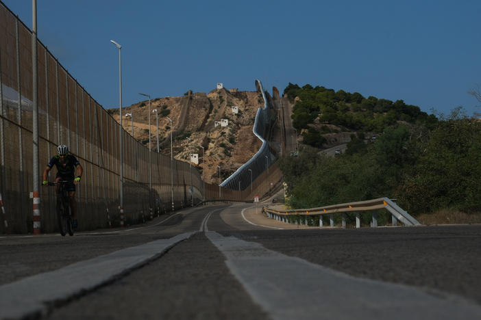 TK EPISODE IS ABOUT THE HILL IN Nador, Morocco ... IS THIS THE SAME HILL? IF NOT, I CAN USE ONE OF THOSE, THIS IS JUST NICER WITH THE VISIBLE BORDERMelilla, Spain (October 13, 2022) - A fence runs all around the land border that Melilla, Spain shares with Morocco.