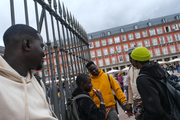 Four young men from Senegal sell bracelets in Madrid on October 20.