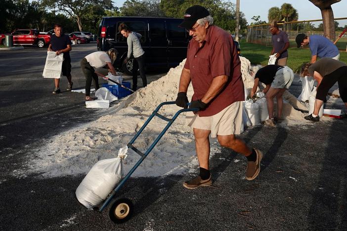 Sandbags are distributed at Mills Pond Park in Fort Lauderdale on Tuesday ahead of subtropical storm Nicole.