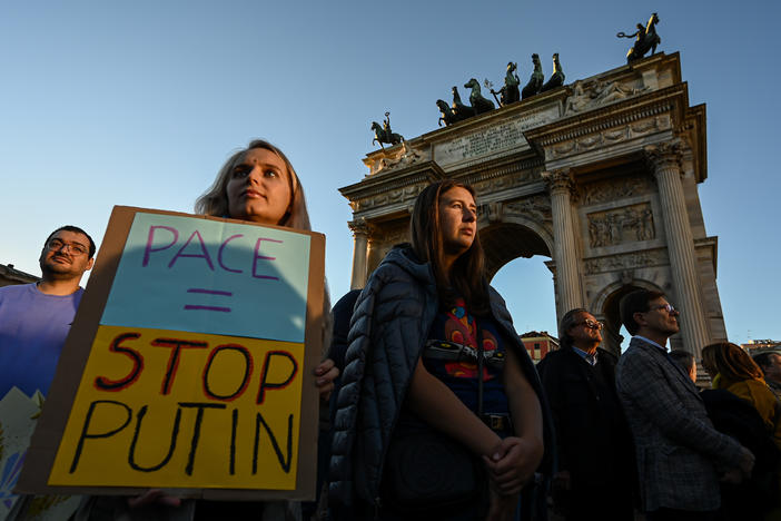 A woman holds a placard reading "Peace = Stop Putin" during a rally in support of Ukraine at Arco della Pace in Milan, Italy on Saturday.