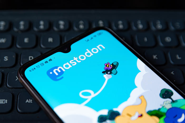 The Mastodon app homepage is seen displayed on a mobile phone screen.