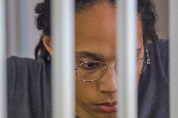 WNBA basketball player Brittney Griner, who was detained at Moscow's Sheremetyevo airport and later charged with illegal possession of cannabis, sits inside a defendants' cage after the court's verdict during a hearing in Khimki outside Moscow, on Aug. 4, 2022.