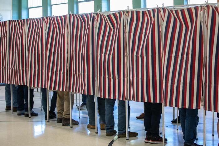 Voters fill out their ballots in Manchester, N.H., on Tuesday. With his victory on Tuesday night, James Roesener became the first openly transgender man elected to a state legislature.