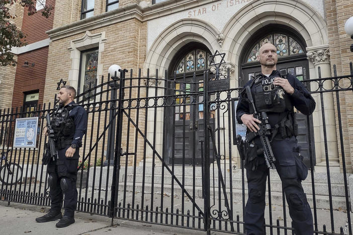 Hoboken Police officers stand watch outside the United Synagogue of Hoboken last Thursday in Hoboken, N.J.