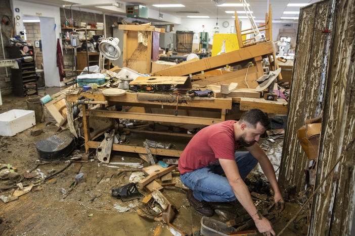 At the Appalachian School of Luthiery in Hindman, Ky., days after July's catastrophic floods, luthier Kris Patrick searches through the mud-caked remains of instruments and materials.