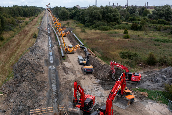 Workers in Germany construct a new pipeline for transporting natural gas imports from a nearby liquified natural gas facility. European countries are seeking new sources of natural gas, as they wean themselves off imports from Russia.