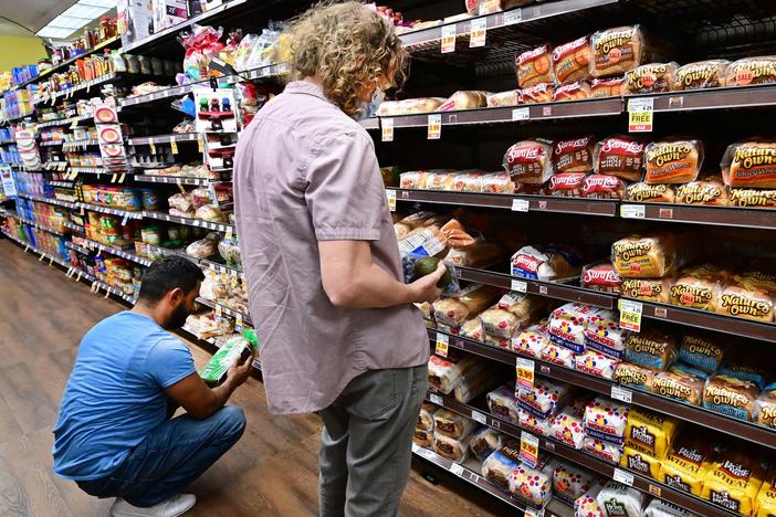 People shop for bread at a supermarket in Monterey Park, California on October 19, 2022. Grocery prices were up 12.4% last month from a year earlier, a government report showed.