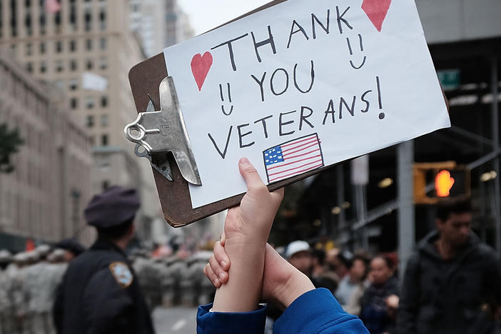 Gavin Kinney holds up a sign thanking veterans at the 2015 Veterans Day Parade in New York City.