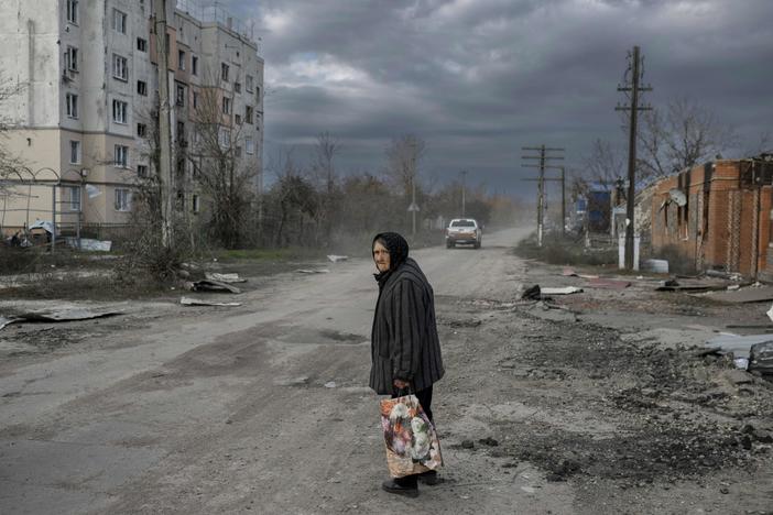 An elderly woman walks in the southern Ukrainian village of Arkhanhelske, outside Kherson, on Nov. 3. The Russians occupied the village until recently. Now Ukrainian forces are moving into villages where the Russians left. The Russians also say they're withdrawing from Kherson, marking another major setback for the Russian military.