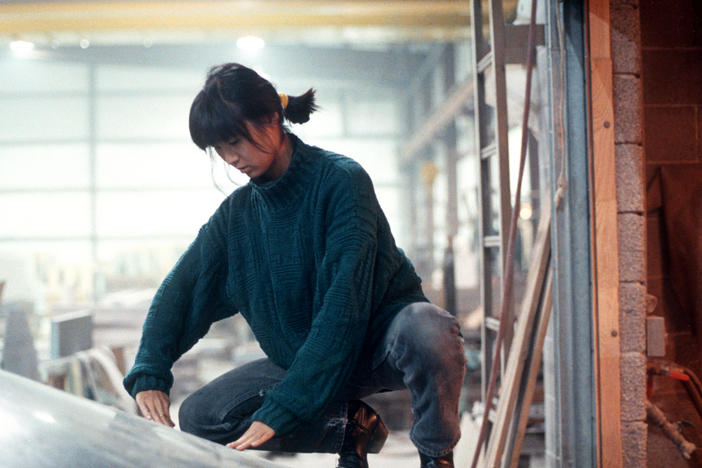 Maya Lin, in 1988, examining inverted water table being fabricated for the Civil Rights Memorial she designed to be installed in Montgomery, Alabama.