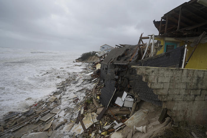 Parts of homes are seen collapsing on the beach due to the storm surge by Hurricane Nicole on Thursday in Wilbur-By-The-Sea, Fla.