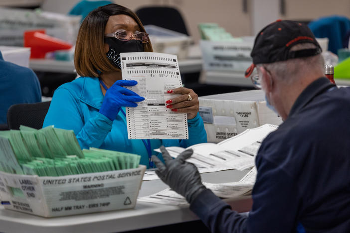 Election workers sort ballots at the Maricopa County Ballot Tabulation Center last week in Phoenix. The election is not considered over until the vote totals are reviewed and certified.