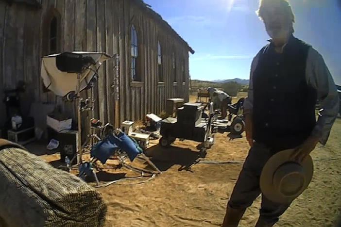 In this image from video released by the Santa Fe County Sheriff's Office, Alec Baldwin stands in costume and speaks with investigators following a fatal shooting last year on a movie set in Santa Fe, N.M.