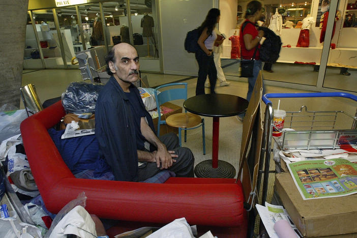 Merhan Karimi Nasseri lived for 18 years in Paris' Charles de Gaulle Airport and inspired the Steven Spielberg film <em>The Terminal</em>. He died Saturday in the airport, officials said.