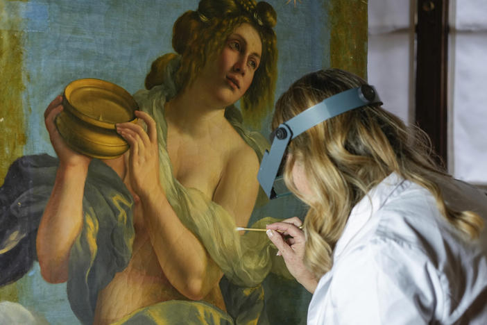 Restorer Elizabeth Wicks works on the <em>Allegory of Inclination</em>, a 1616 work by Artemisia Gentileschi, in the Casa Buonarroti Museum, in Florence, Italy, on Wednesday.