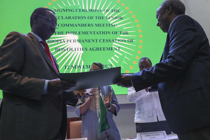 Chief of Staff of Ethiopian Armed Forces Field Marshall Birhanu Jula, left, and Head of the Tigray Forces Lt. Gen. Tadesse Werede, right, exchange signed copies of an agreement, at Ethiopian peace talks in Nairobi, Kenya, on Saturday.