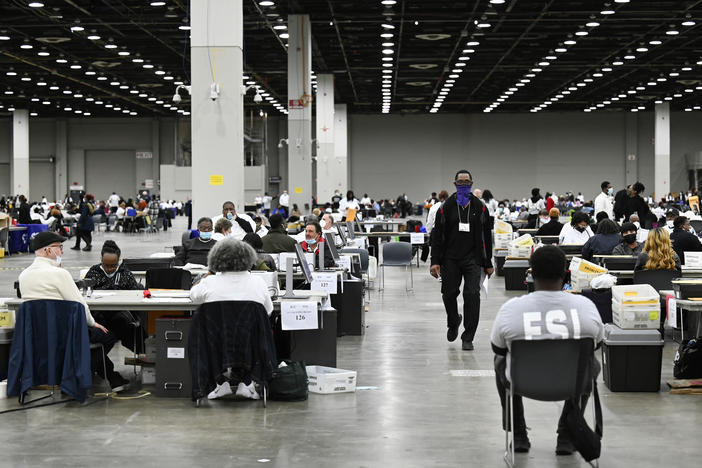 Ballot counters process absentee ballots on Nov. 8 at Huntington Place in Detroit. The scene this year was much calmer than 2020, when protesters descended on Detroit and yelled for election officials to "stop the count!"