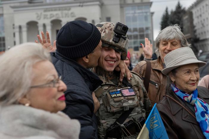 A man hugs a Ukrainian soldier as local residents gather to celebrate the liberation of Kherson on Sunday.