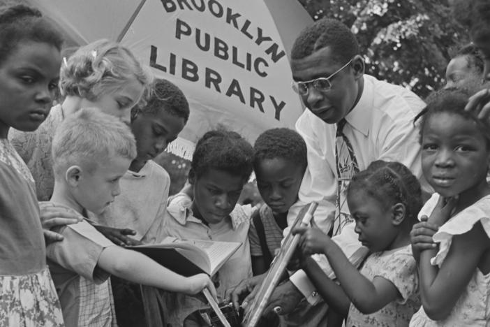 Children read outdoors at an event organized by the Brooklyn Public Library in New York City in August 1950.