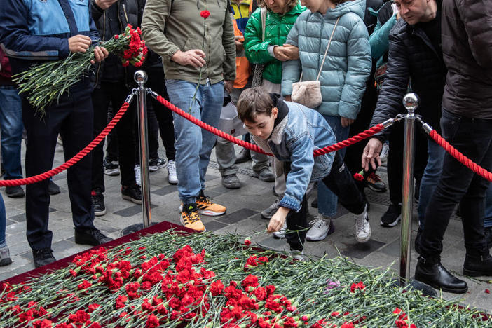 On Monday, people lay flowers to pay tribute to the victims of a Sunday's blast that took place on Istanbul's famous Istiklal Avenue in Istanbul, Turkey.
