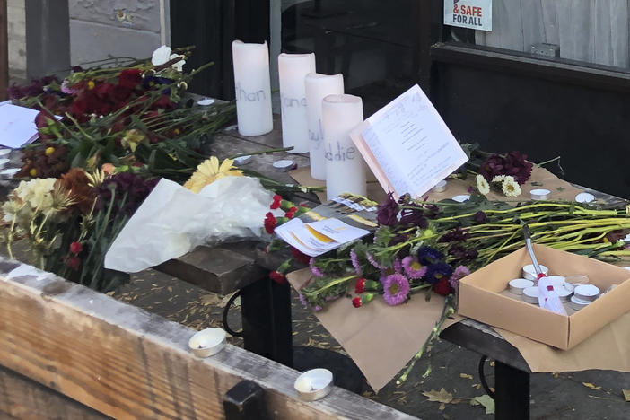 Candles and flowers are left at a  memorial honoring four slain University of Idaho students at the Mad Greek restaurant in Moscow, Idaho, on Tuesday. Two of the victims, Madison Mogen, 21, and Xana Kernodle, 20, were servers at the restaurant.