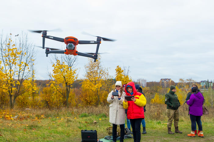 Yevhenia Podvoiska and Tatiana Kuznetsova, from left, both policewomen, steer and navigate a drone during class in Kyiv on Oct. 27. Students must learn to work in pairs: a pilot and a navigator.