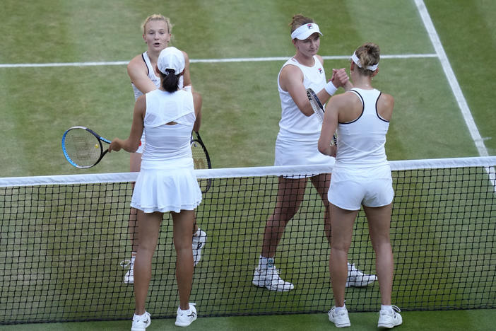 Barbora Krejcikova, top right, and Katerina Siniakova of the Czech Republic, celebrate after beating China's Shuai Zhang, bottom left, and Belgium's Elise Mertens during the final of the women's doubles at the Wimbledon tennis championships in July. Wimbledon is relaxing its requirement for all-white clothing to allow female players to wear colored undershorts.