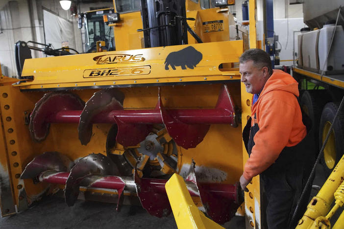 Heavy equipment operator Don Beitz walks around a giant snow thrower while preparing for the impending snowstorm that is expected to dump several feet of snow on the area until Friday evening at the New York State Thruway's Walden Garage in Cheektowaga, N.Y. on Thursday, Nov. 17, 2022.