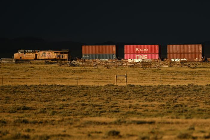 A Union Pacific freight train carries cargo along a rail line at sunset in Bosler, Wyoming, on August 13, 2022.