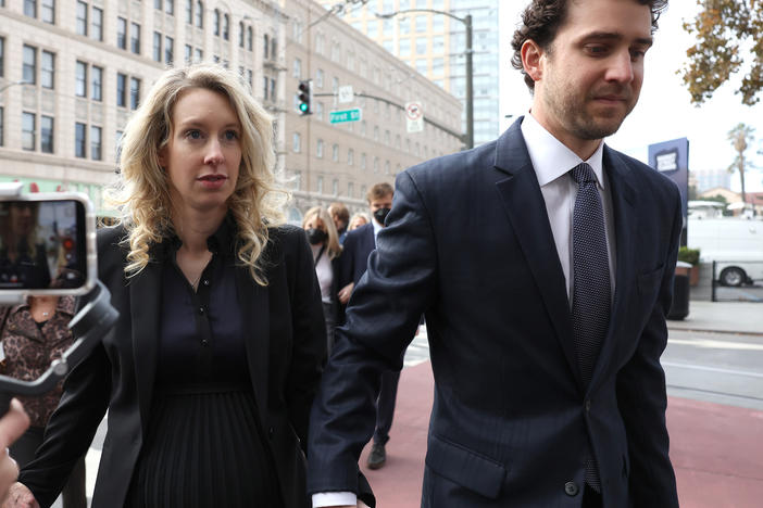 Former Theranos CEO Elizabeth Holmes arrives for her sentencing at federal court with her partner Billy Evans in San Jose, California. Holmes was convicted of four counts of fraud for allegedly engaging in a multimillion-dollar scheme to defraud investors.