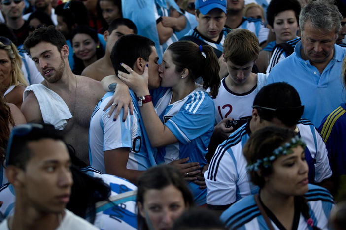 Argentina fans kiss in the crowd while watching the World Cup final in Rio de Janeiro, Brazil in 2014.