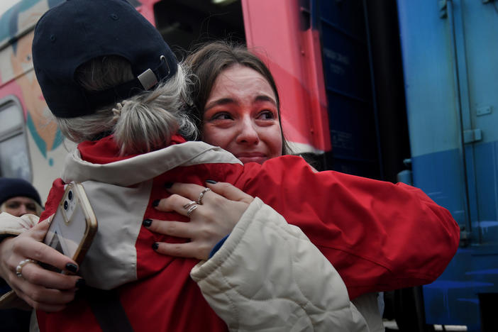 Liudmyla, left, embraces her granddaughter, Ania, who arrived Saturday on the first Ukrainian Railways train to reach liberated Kherson, Ukraine. The train from Kyiv arrived to jubilation and tears.
