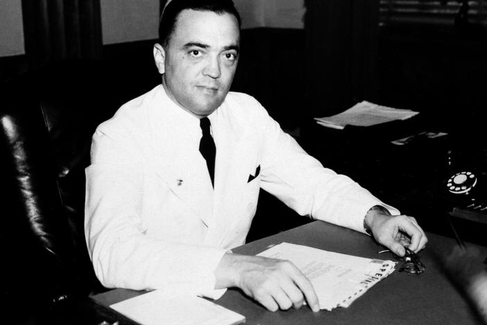 J. Edgar Hoover is seen in his Washington, D.C., office in 1936. A new biography of the long-time FBI director looks at public support for his policies during most of his tenure.