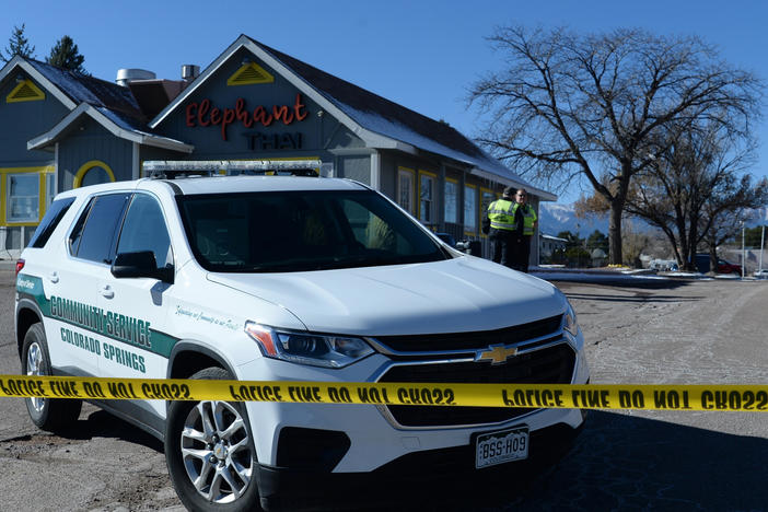 A Colorado Springs community service vehicle is parked Sunday near a gay nightclub in Colorado Springs, Colo., where a shooting occurred late Saturday night.