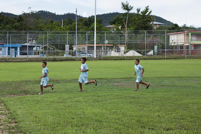 Brothers Ian, Jahxiel and Isaac RodrÃÂ­guez run the bases at the damaged baseball park in their neighborhood, Lajas Arriba, in Lajas, Puerto Rico.