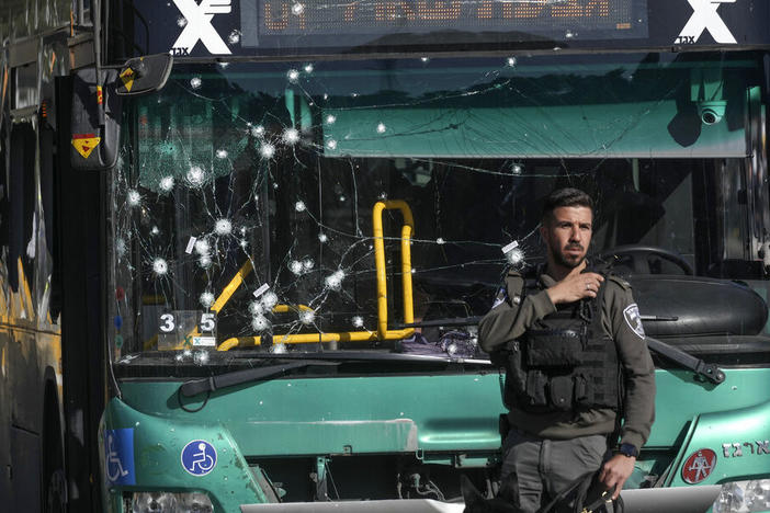 Israeli police inspect the scene of an explosion Wednesday at a bus stop in Jerusalem.