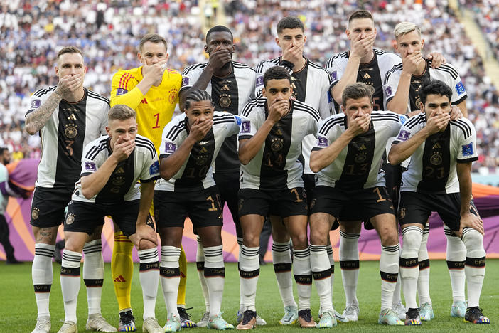 Players from Germany pose for the team photo as they cover their mouth during the World Cup group E soccer match between Germany and Japan on Wednesday.
