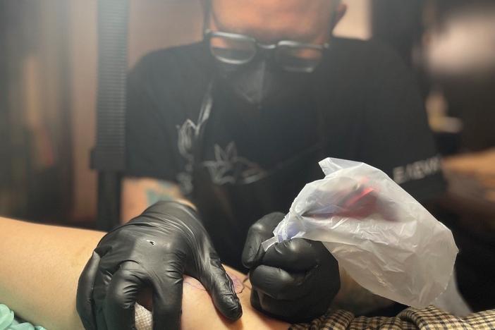 Tattoo artist Cedre Csillagi has completed 11 of what will eventually be 1,000 pansy tattoos.