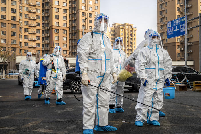 Workers wear protective gear in a Beijing neighborhood placed under lockdown in November. China had raised hopes by slightly relaxing its zero-COVID policy, but cities have been contending with a surge in cases.