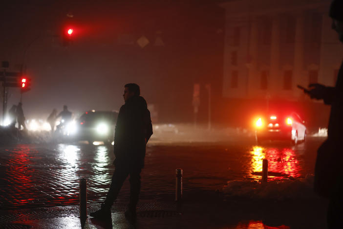 Ukrainians walk through the unlit streets of the capital Kyiv on Thursday, a day after Russian airstrikes knocked out electricity, heating and water to much of the country. With Russian troops faring poorly on the battlefield, Russia has launched a widespread bombing campaign directed at civilian infrastructure in Ukraine.